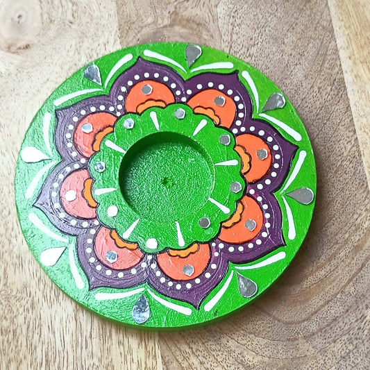 Decorative circular plate with mandala design on a wooden surface