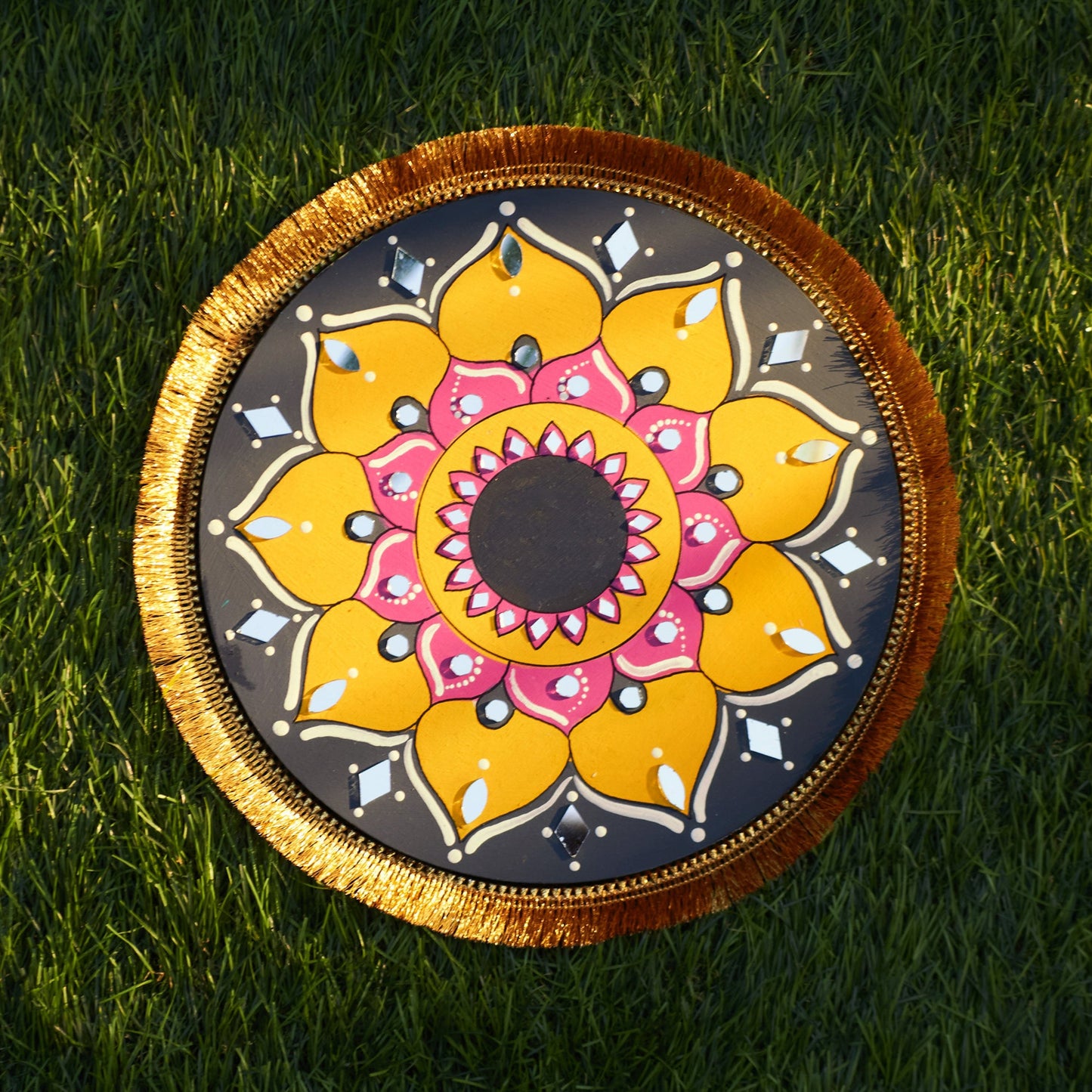Decorative circular plate with a floral design on grass
